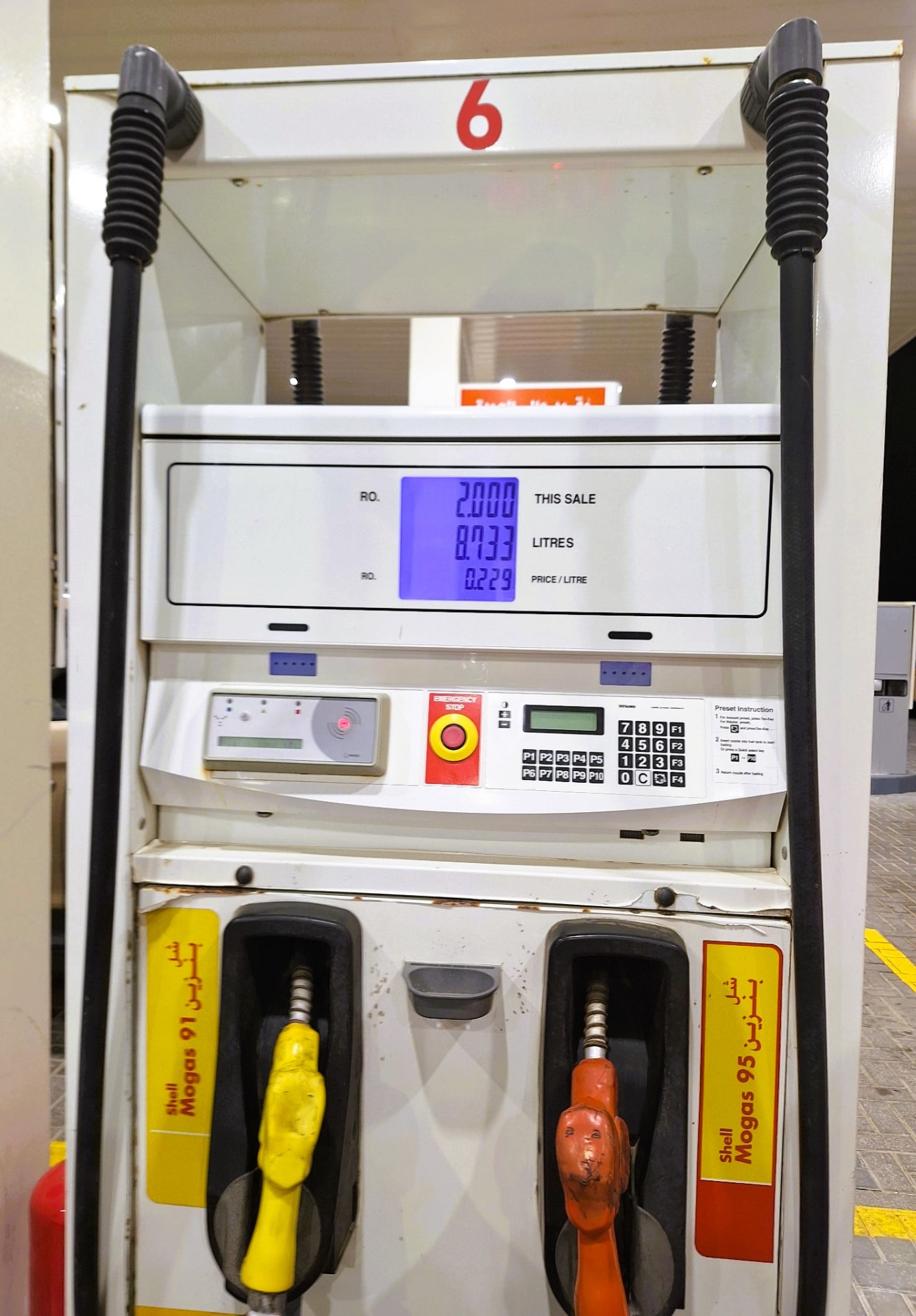 Palivový stojan Shell s digitálním displejem, dvěma černými hadicemi v Salalah